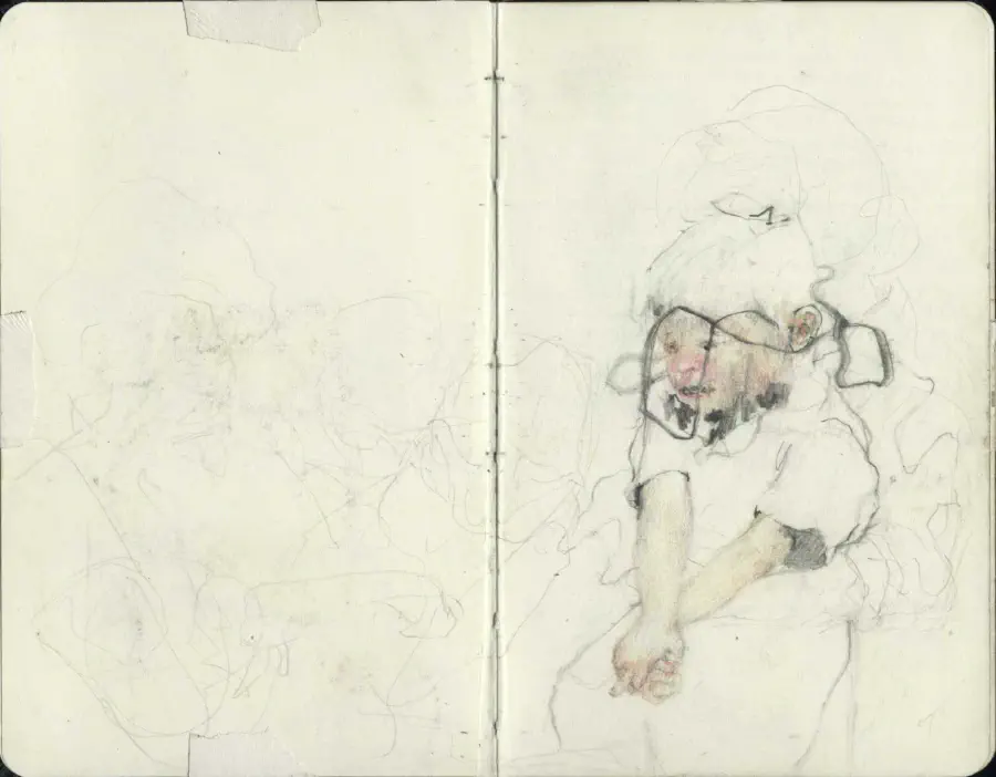A book spread outstretched. The paper is a creamy white. There is a drawing of a child with a haloed line around their head.