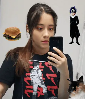 A photo of a woman with a ponytail taking a mirror selfie with a render of Hiei from Yu Yu Hakusho by one shoulder and a cheeseburger by another. A cat render is at the bottom right.